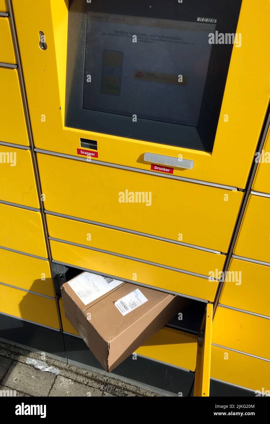 09.04.2022, Germany, Berlin, Berlin - Parcel in an open compartment of a parcel pickup station of the shipping service provider DHL. 00S220409D274CARO Stock Photo