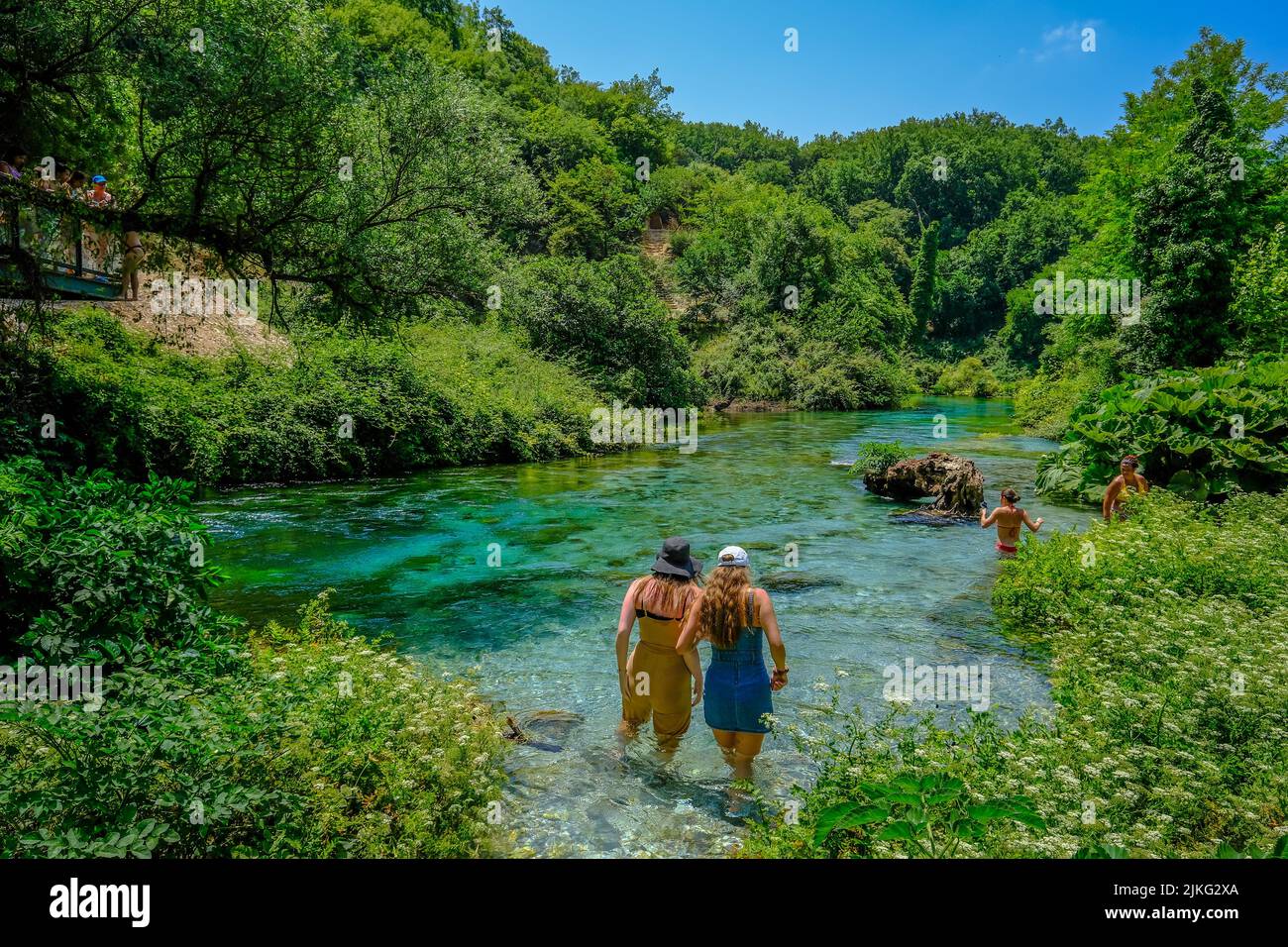 29.06.2022, Albania, Muzina, Muzina - Tourists bathe in the Syri i Kaltër, THE BLUE EYE, is with 6 m /s the water richest source of the country. The w Stock Photo