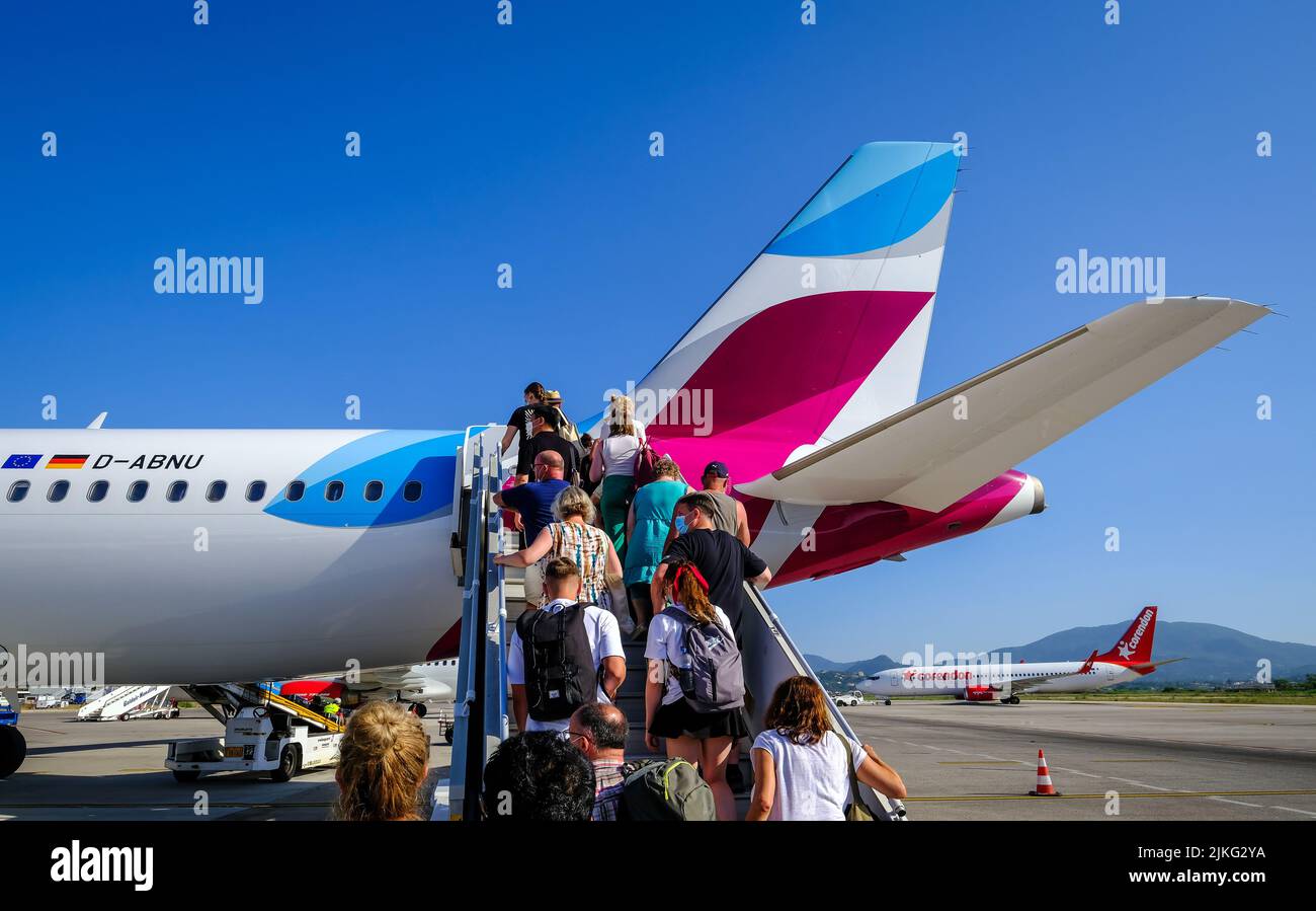 01.07.2022, Greece, Corfu, Corfu - EUROWINGS. At Corfu Airport, vacationers board a Eurowings aircraft, here an Airbus A320, via an external staircase Stock Photo
