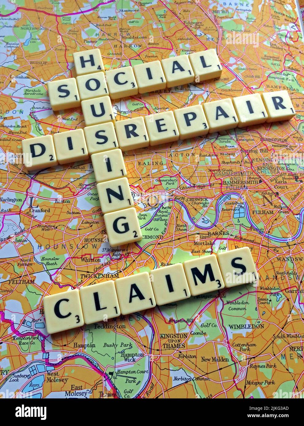 SocialHousing / Council Housing Disrepair problems with responsive repairs spelled out in Scrabble letters on a map Stock Photo