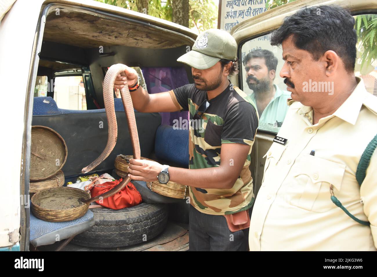 Wildlife expert Abhilash Varshney shows a Cobra snake for awareness on