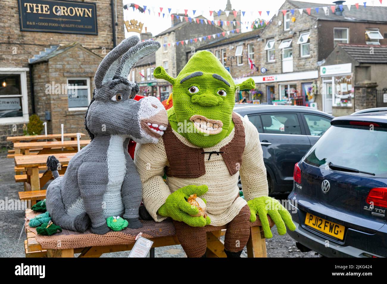 Hawes village in the Yorkshire Dales, life size knitted Shrek characters displayed for charitable fundraising outside the Board Inn,Yorkshire,England Stock Photo
