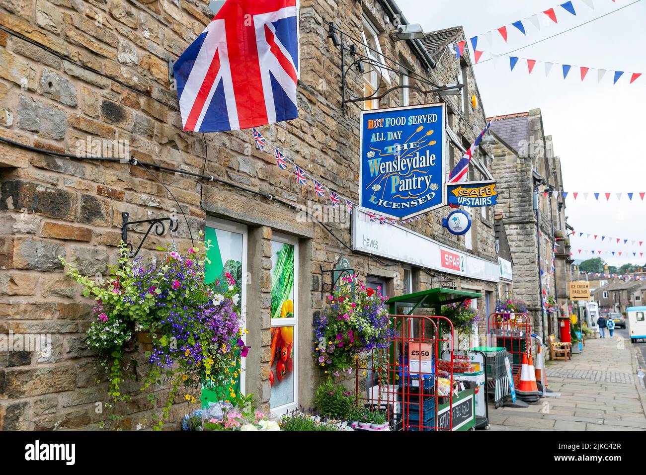 Wensleydale Pantry cafe restaurant in Hawes, a market town in the Yorkshire Dales national park,England,UK summer of 2022, Union Jack flying and bunti Stock Photo