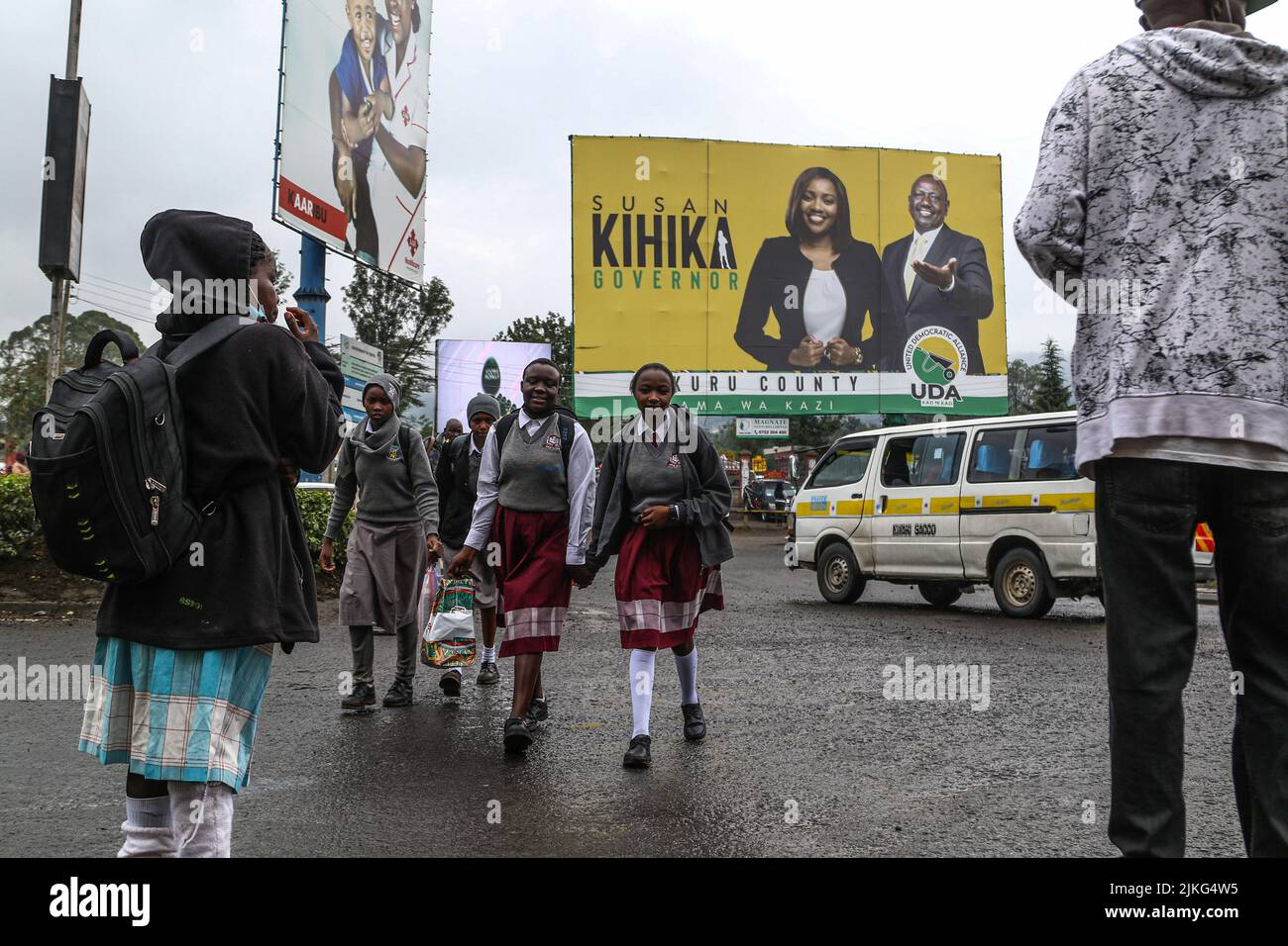 Nakuru, Kenya. 02nd Aug, 2022. Students walk past a billboard bearing the images of Kenya Kwanza Presidential flag bearer, William Ruto, and Nakuru county gubernatorial candidate, Susan Kihika. Schools have been closed in preparation for Kenya's General election to be held on August 9, 2022. Credit: SOPA Images Limited/Alamy Live News Stock Photo