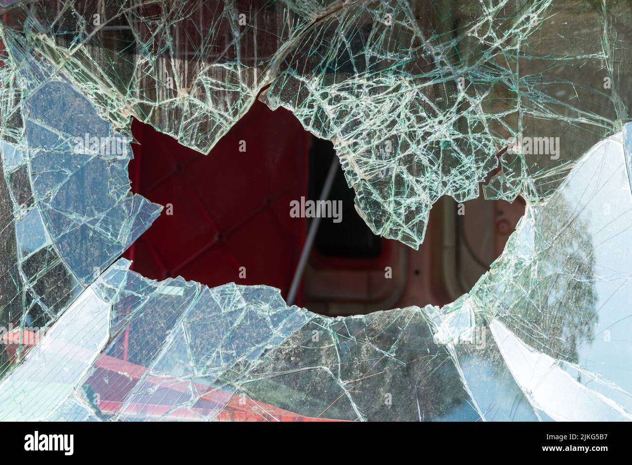 Broken windshield of the car. The car got big hole at windshield