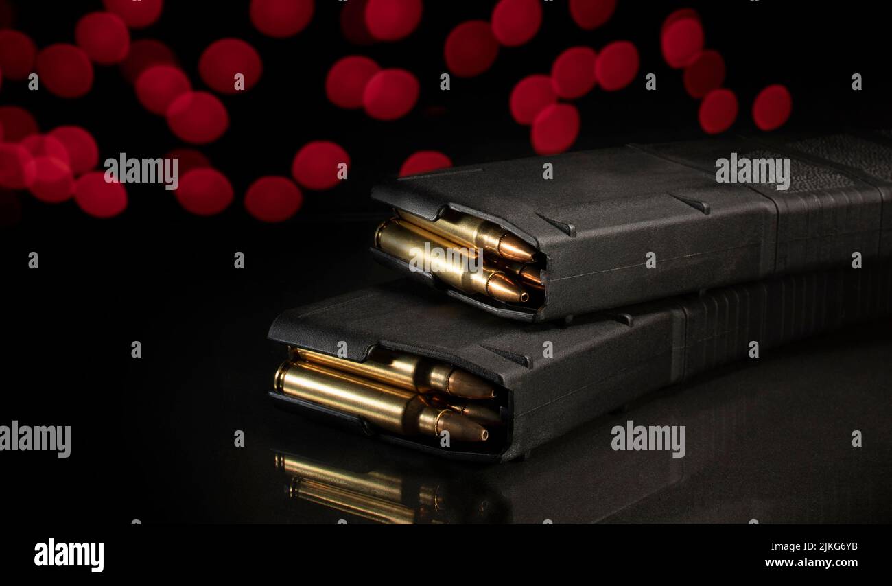 AR15 magazines loaded with ammo with red Christmas lights behind Stock