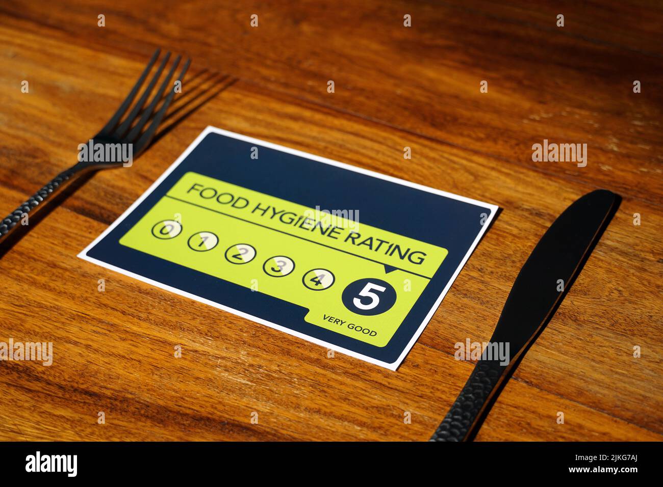 Food Hygiene Rating 5. Very Good Food Hygiene Rating from the United Kingdom Food Standards Agency on wooden background. Stock Photo
