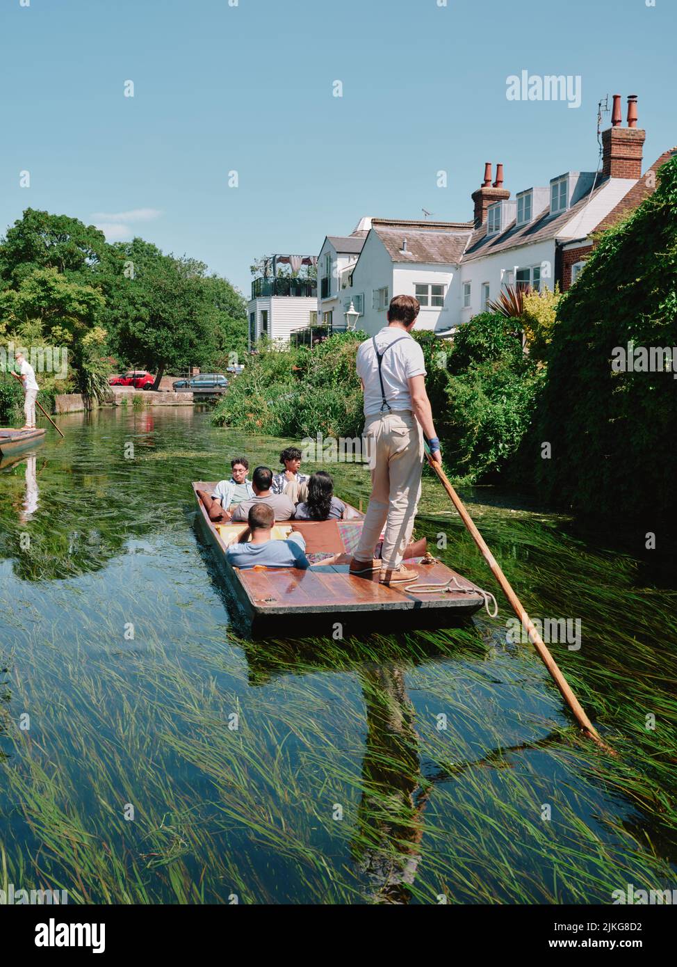 Summer tourists visitiors enoying a punt boat tour along the river Stour through the centre of old Canterbury Kent England UK - tourism punting summer Stock Photo