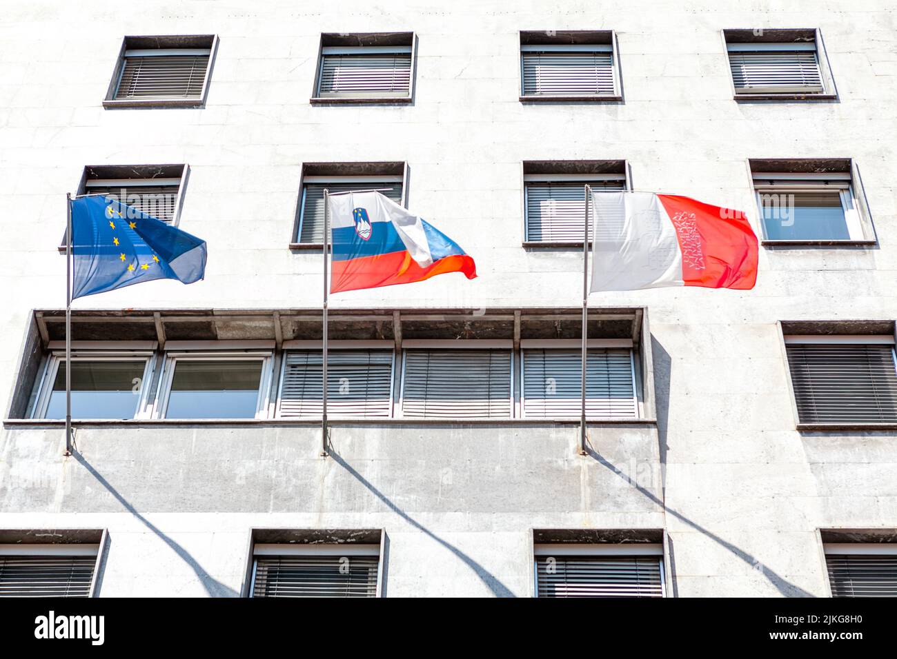 Academy of Music in Ljubljana . National flags of Slovenia and Uniunea Europeana Stock Photo