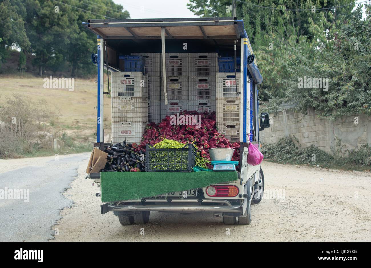 Street vegetable seller truck full of capia and green peppers, eggplants. Traditional way of grocery trade in old towns in Turkey. Stock Photo