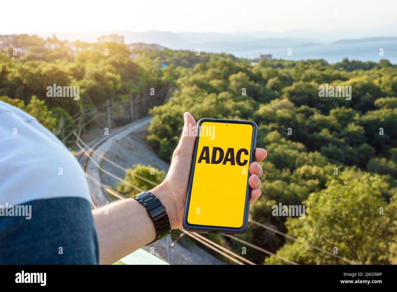 30 July 2022: Man Uses His Smartphone On A Trip And Shows The ADAC Der Allgemeine Deutsche Automobil Club E. V. App On The Screen, PHOTOMONTAGE Stock Photo