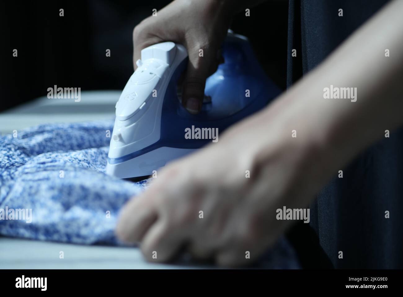 Laundry Services. Woman Hand Ironing Cloth On Ironing Board Stock Photo -  Alamy