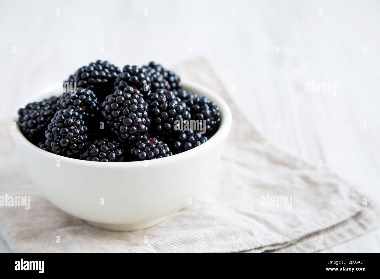 Raw Blackberries in a Bowl, side view. Space for text. Stock Photo