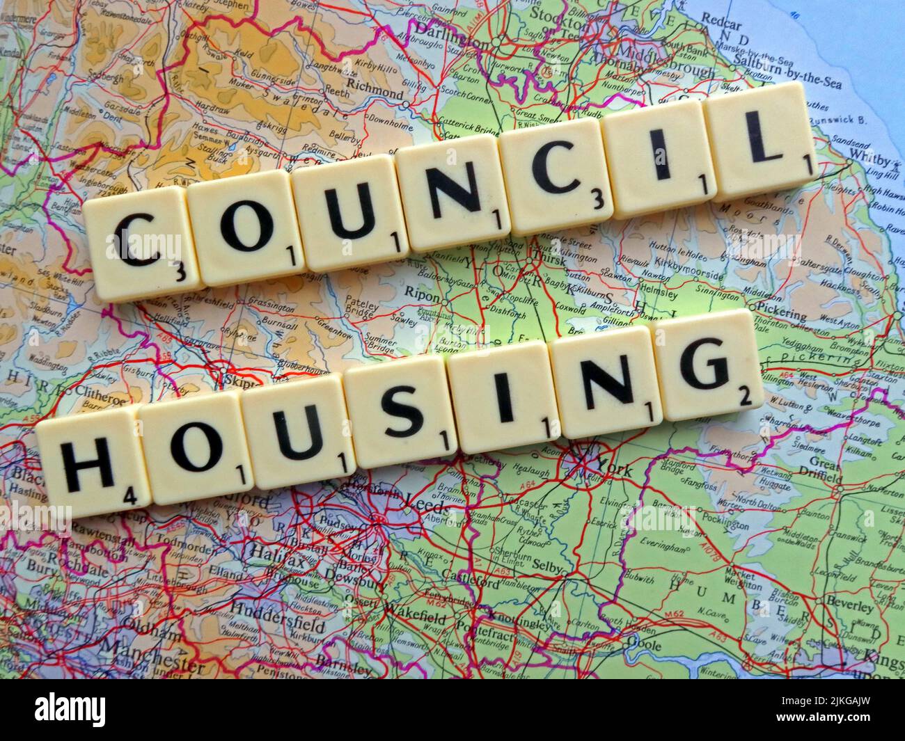 Council Housing spelled out in Scrabble letters on a map of England, a policy already rejected by Scotland and Wales assembles Stock Photo