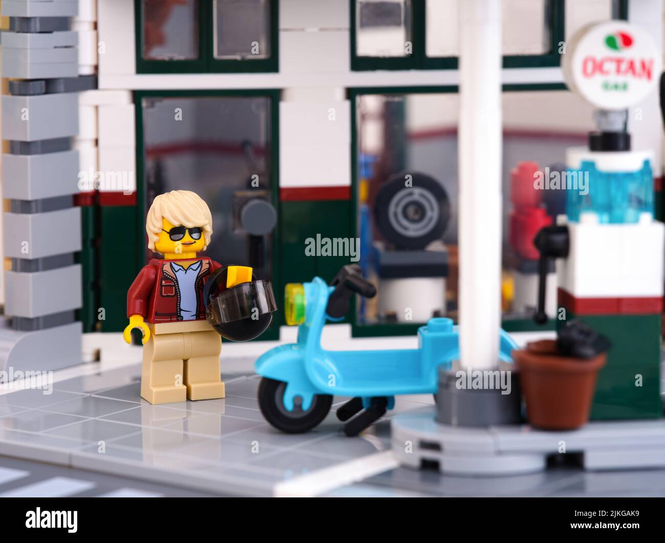 Tambov, Russian Federation - January 03, 2022 Lego woman minifigure walking towards her moped that has just been filled up with a fuel Stock Photo
