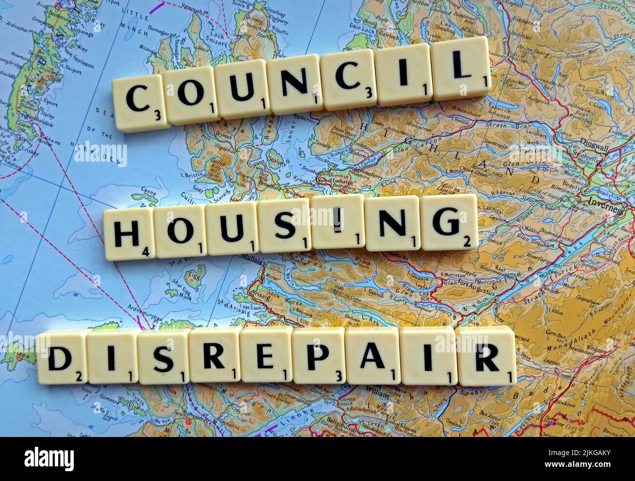 SocialHousing / Council Housing Disrepair problems with responsive repairs spelled out in Scrabble letters on a map of Scotland Stock Photo