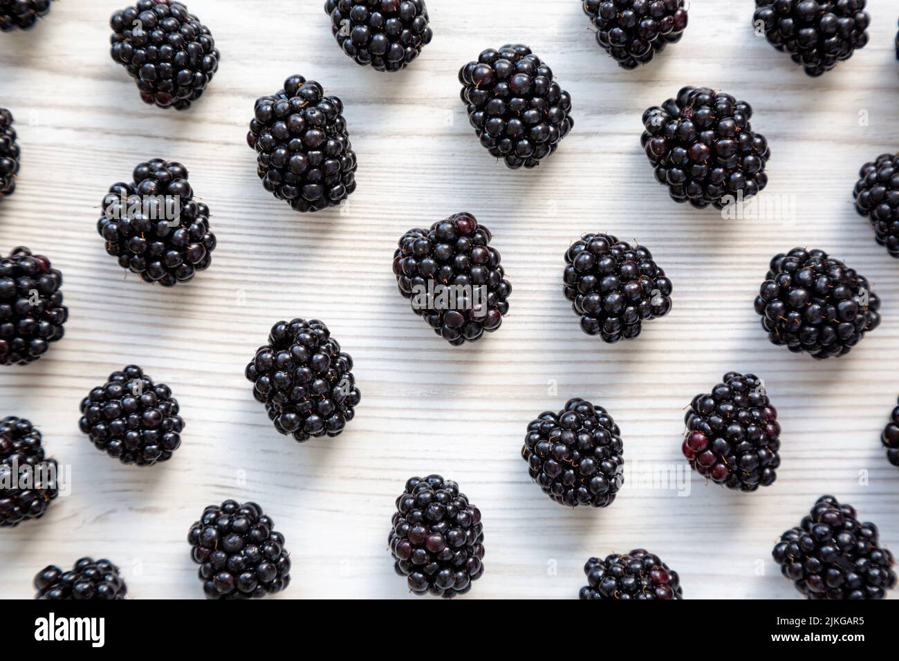 Raw Blackberries on a white wooden background, top view. Flat lay, overhead, from above. Stock Photo