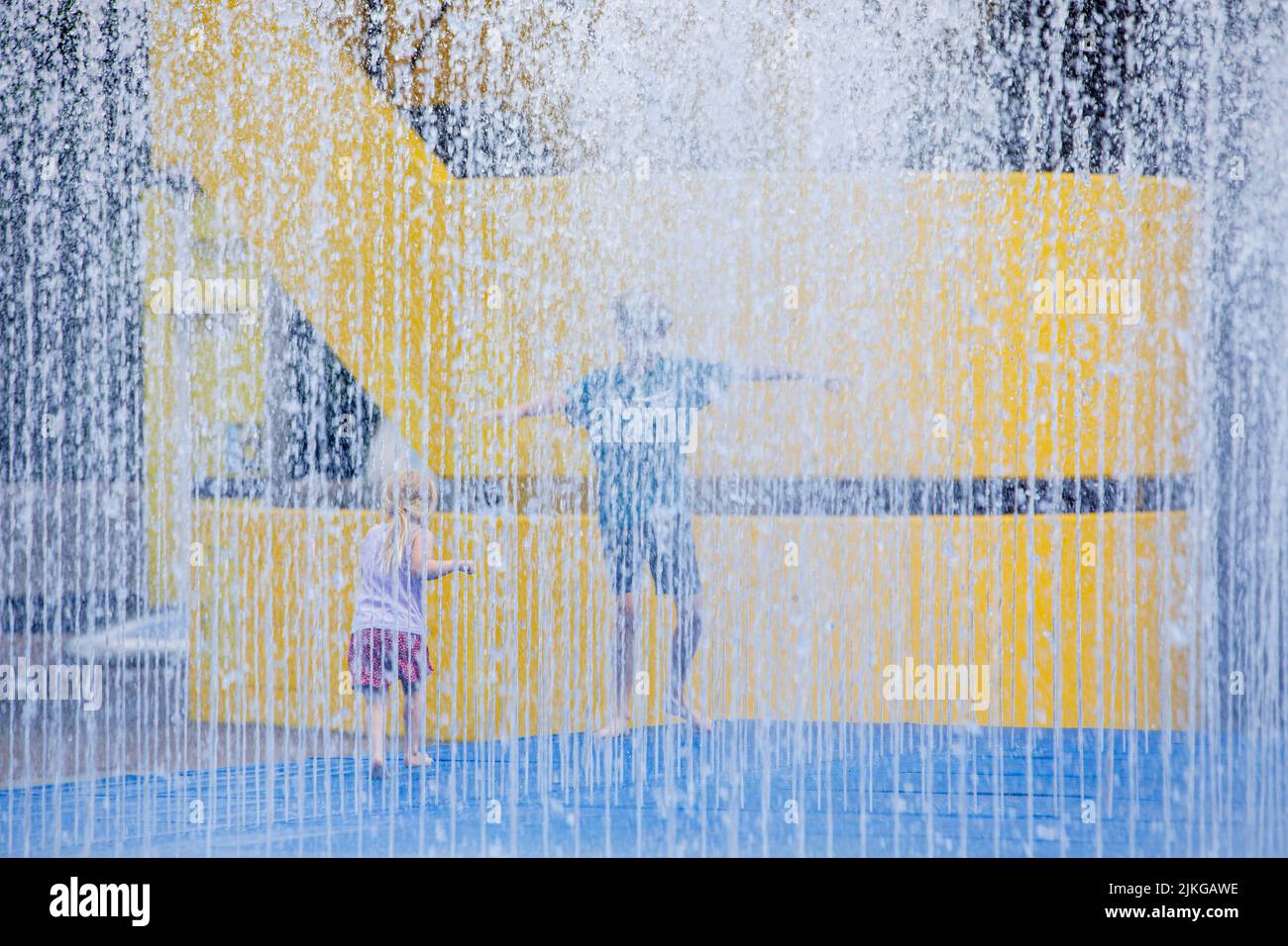 Children play i a water feature at the Southbank Centre, London, UK. Stock Photo