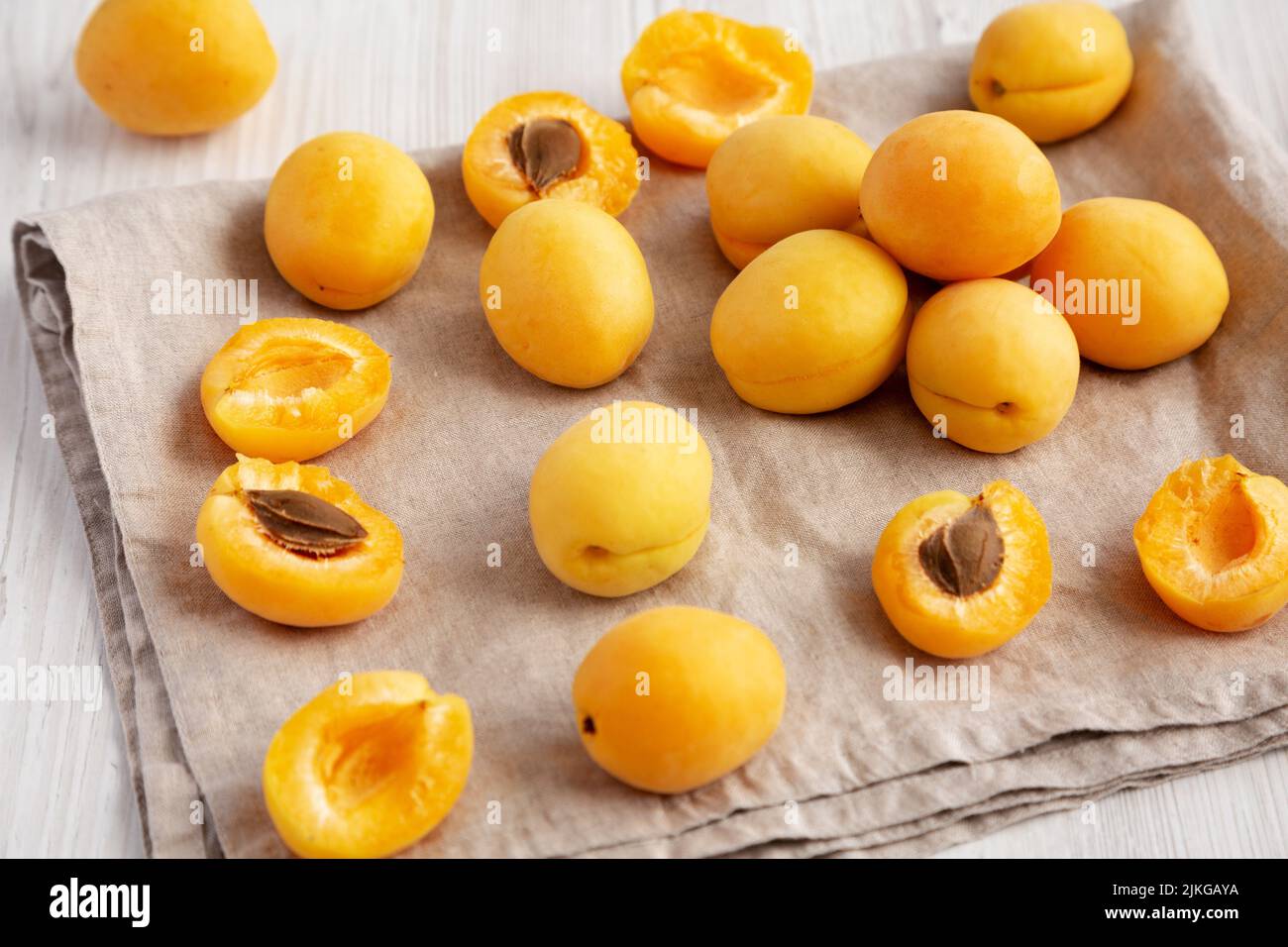 Raw White Apricot Angelcots on a white wooden background, low angle view. Stock Photo