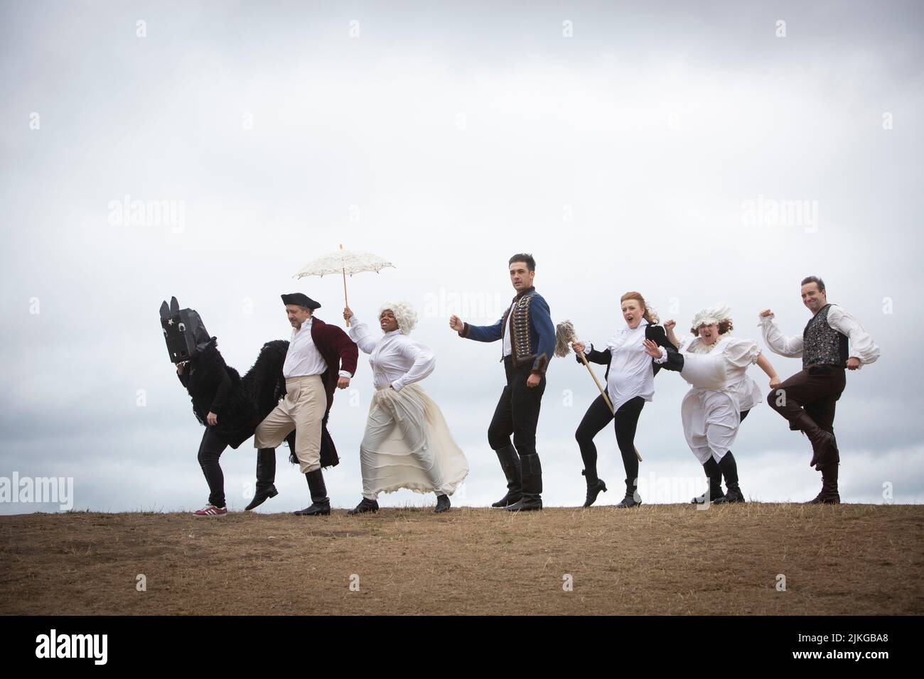 Edinburgh. Scotland. UK. 2nd August 2022. Photocall: Literary closing and slapstick on Calton Hill. The Fringe the six actors from the brilliantly fast paced slapstick romp Classic! (daily 3- 29 August Pleasance 1) will wear a smorgasbord of 17th, 18th, and 19th century costumes (think wigs, parasols, long velvet, military jackets and jolly jack tars). With props including trumpets, parasols, a pantomime horse, very unperiod water pistols and a bright pink melodica). They will be clowning and posing with the city behind them and on The National Monument of Scotland. Pic: Pako Mera/Alamy Li Stock Photo