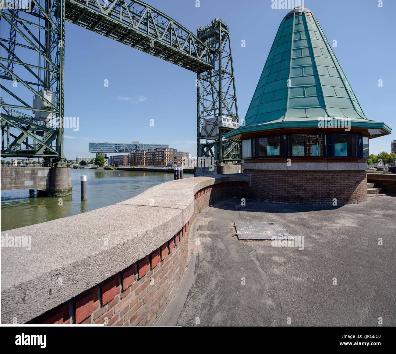 Gatekeeper house with in the background De famous bridge de Hef ( Koningshaven bridge) and the Unilever head office, Rotterdam, the Netherlands Stock Photo