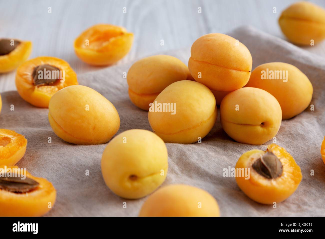 Raw White Apricot Angelcots on a white wooden background, low angle view. Close-up. Stock Photo