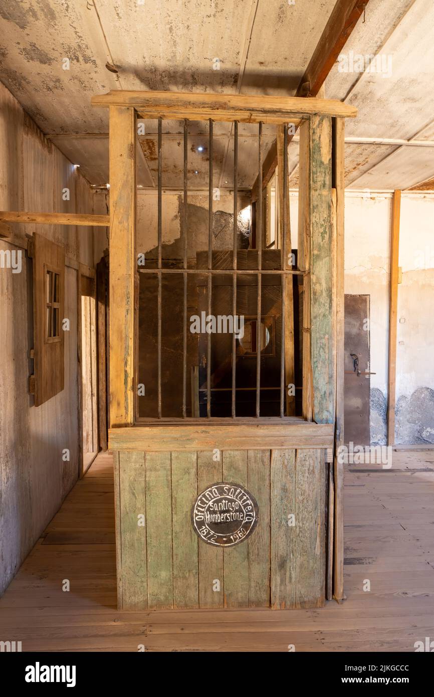 A barred window from the former saltpeter company town of Humberstone, Chile.  Now a ghost town and museum. Stock Photo