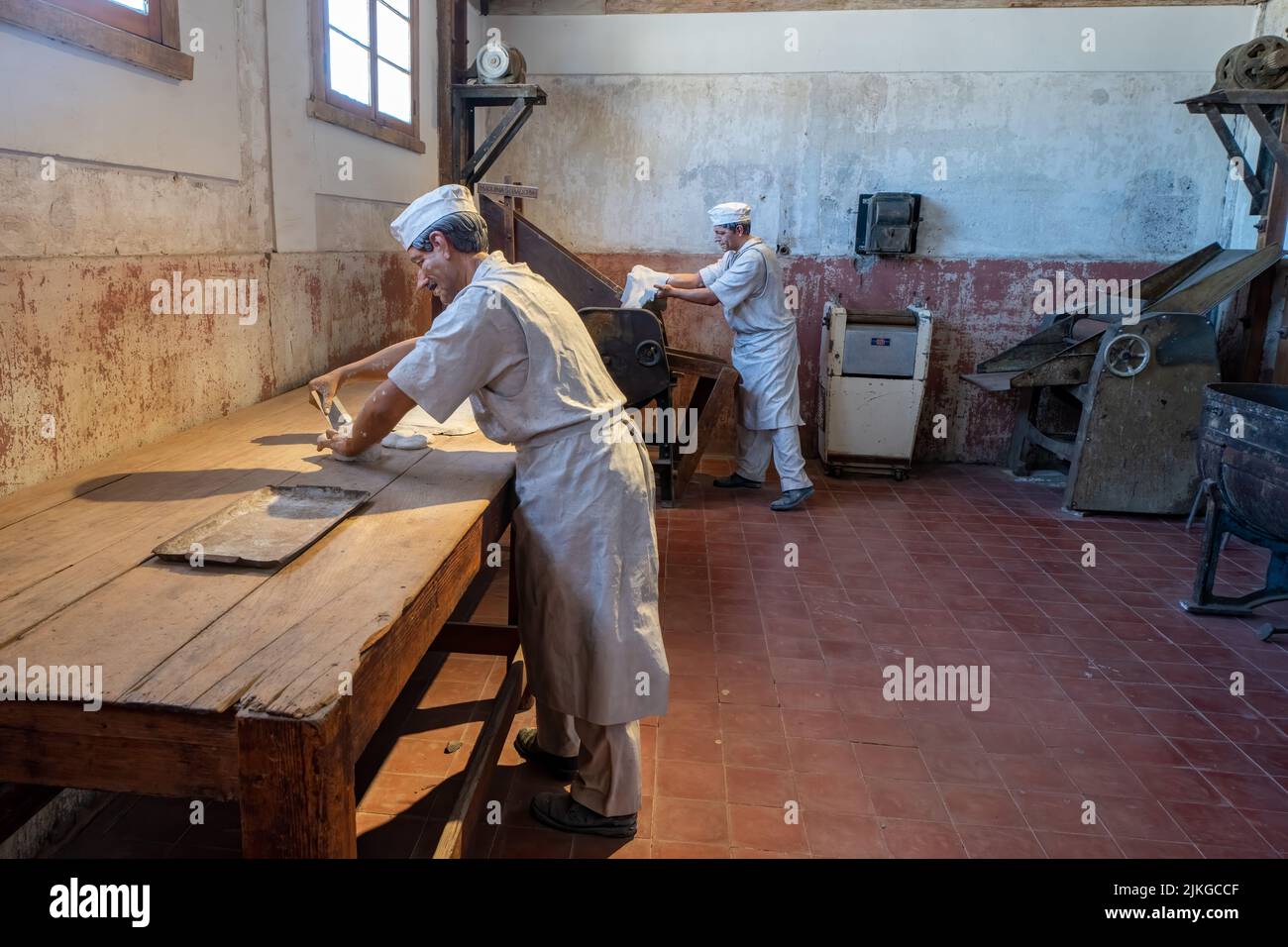 A display of the company store in the former saltpeter company town of Humberstone, Chile.  Now a ghost town & museum.  Bakers kneading bread dough sh Stock Photo