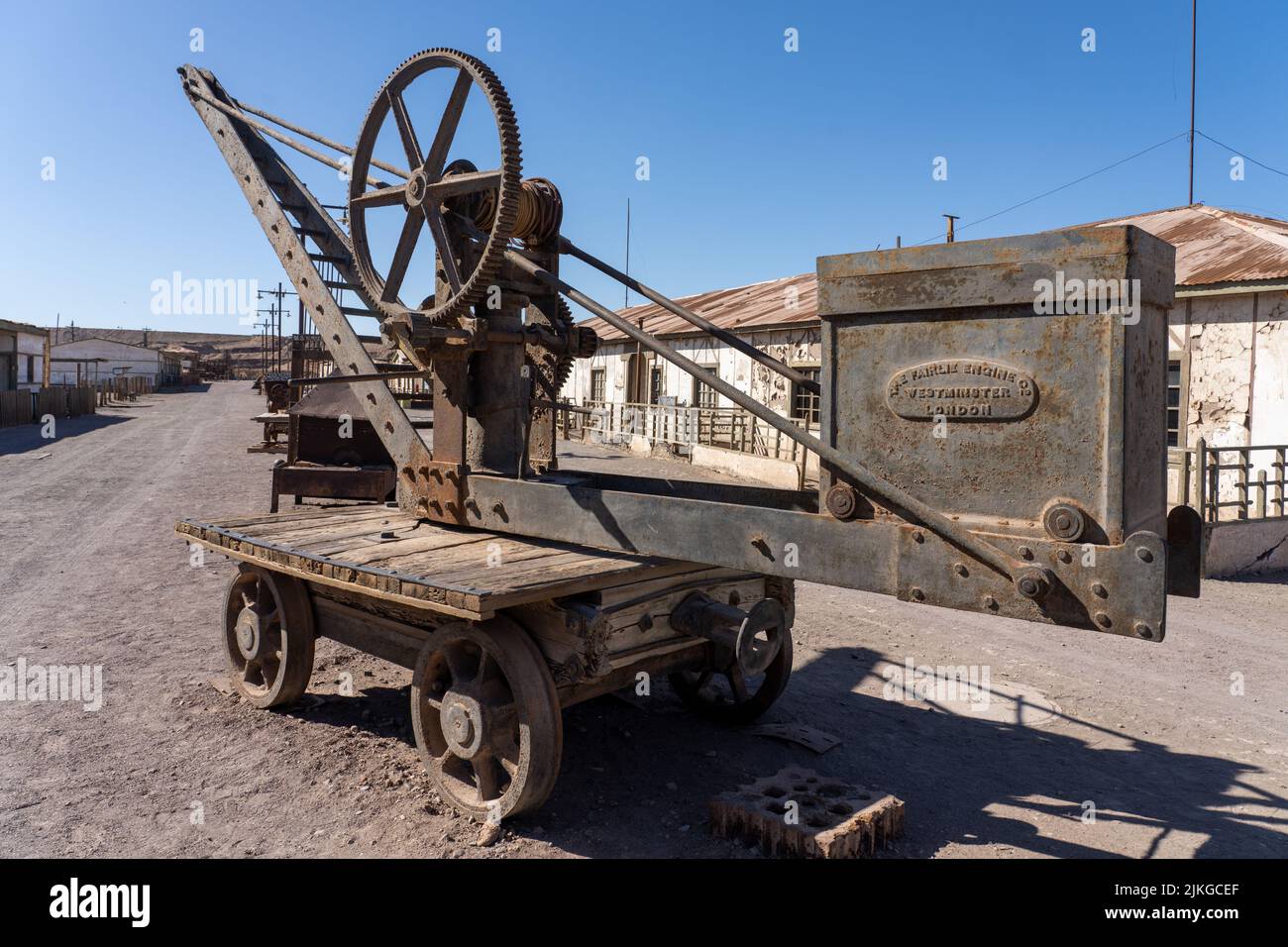 Outdoor museum display of an old lifting crane on rail tracks used in the saltpeter works in Humberstone, Chile. Stock Photo
