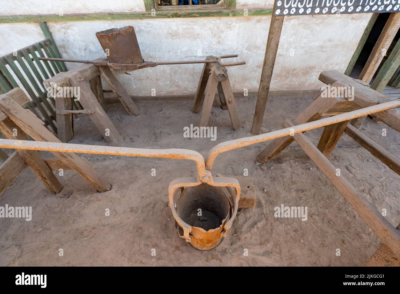Museum display of buckets with carrying handles for use in the saltpeter works in Humberstone, Chile. Stock Photo