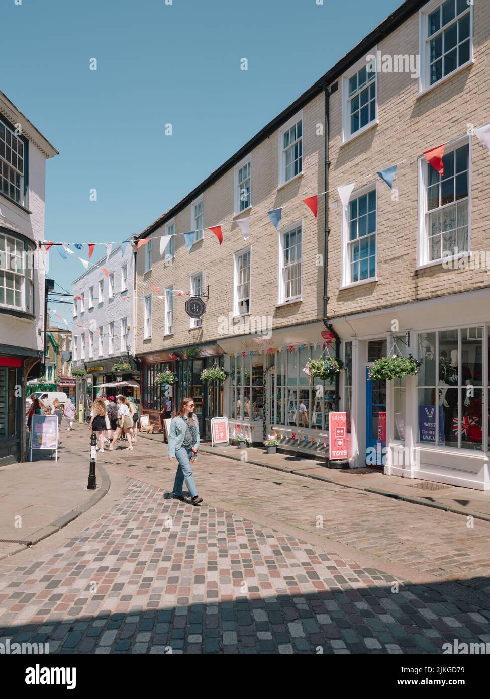 The summer shopping streets and tourists in the very heart of Old Canterbury Kent England UK  -  tourism tourists cafes shops bunting Stock Photo