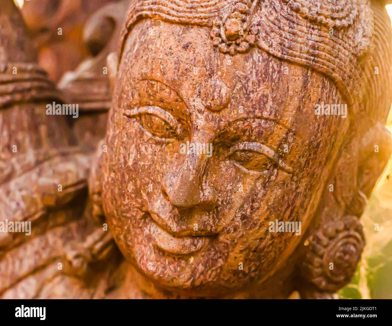 Head shot of the Hindu goddess Sarasvati. An ornately sculpted statue of goddess Saraswati, the goddess of knowledge, music, art, wisdom, and nature. Stock Photo