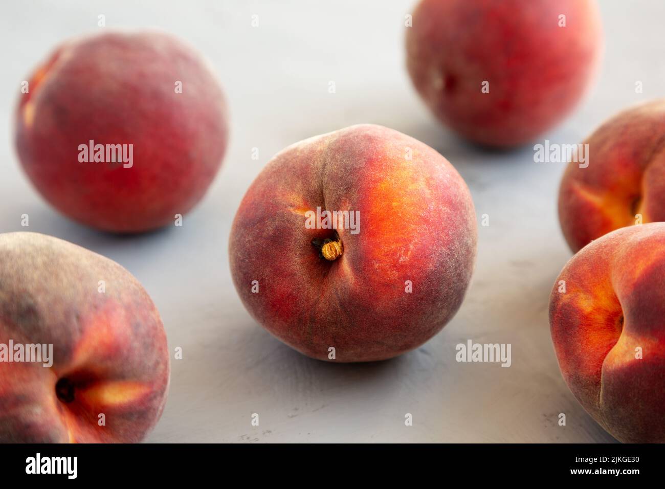 Raw Organic Yellow Peaches on a gray background, side view. Stock Photo