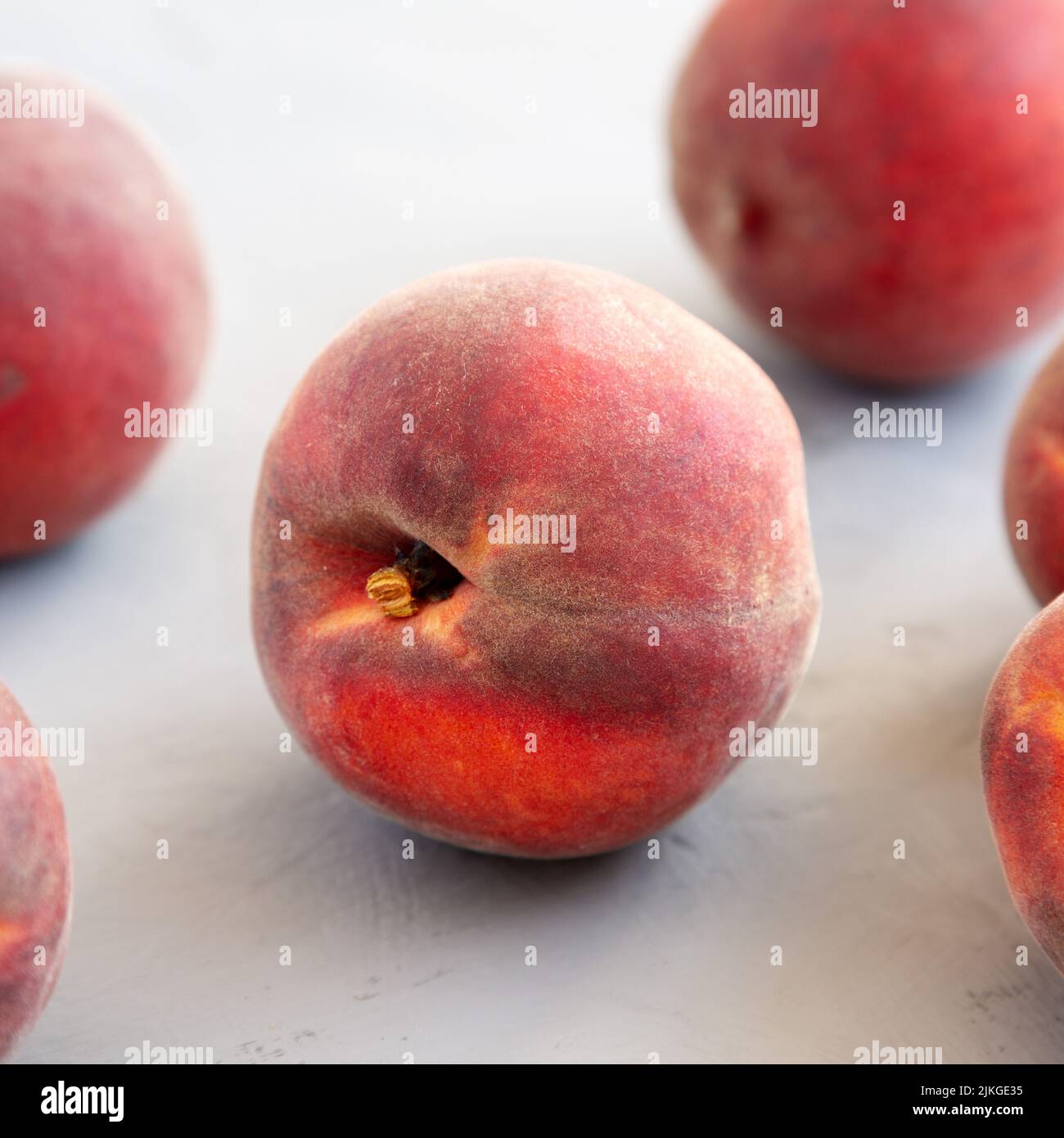 Raw Organic Yellow Peaches on a gray background, side view. Close-up. Stock Photo