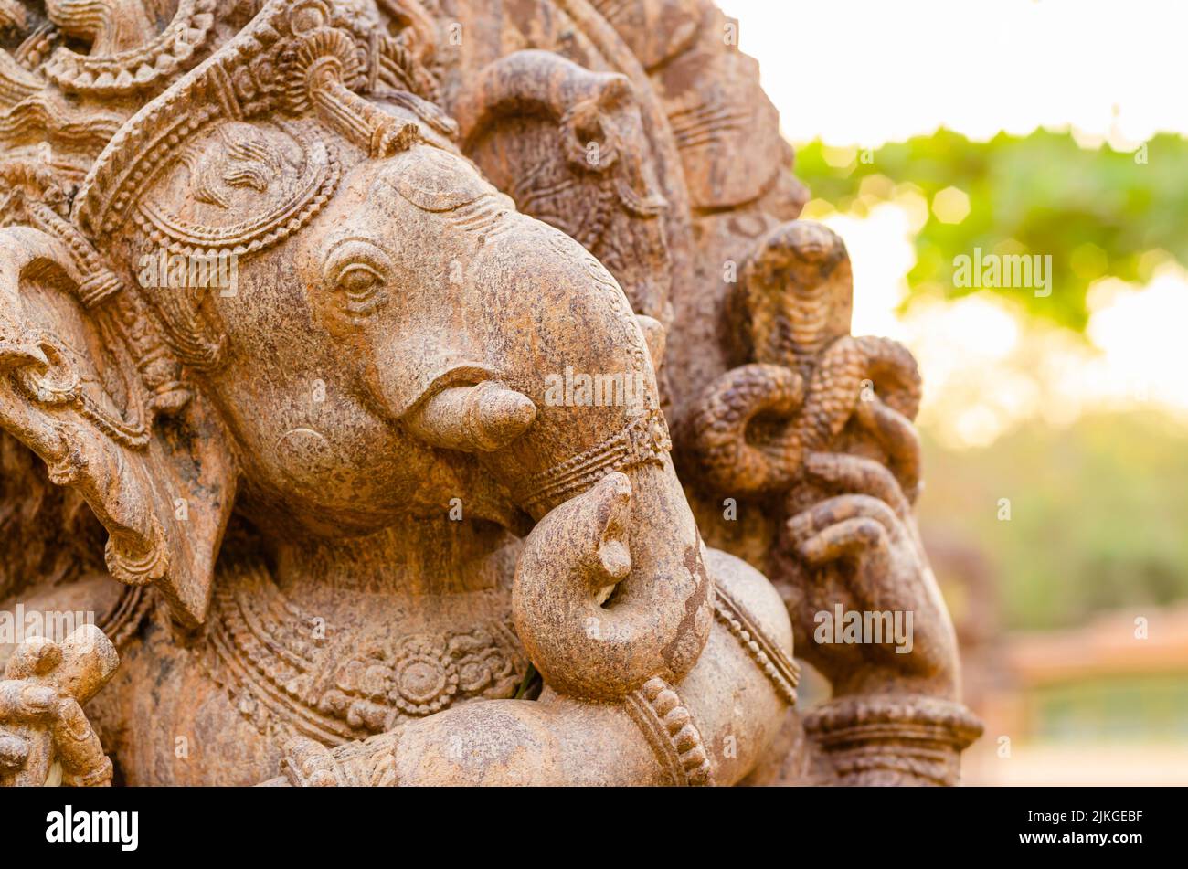 Side view of the head of Lord Ganesh / Ganesha / Ganesa. Head shot of a stone statue of Hindu God of Wisdom. Stock Photo
