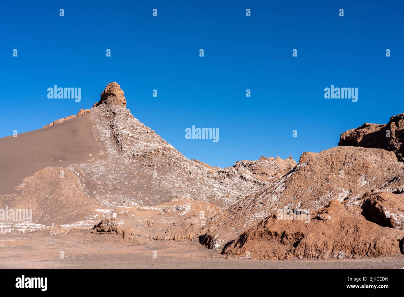 Salt deposits on siltstone rock formations in the Valley of the Moon or Valle de Luna near San Pedro de Atacama, Chile. Stock Photo