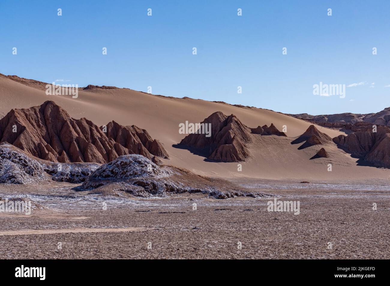 Sand dunes and siltstone formations in the Salt Mountains in the Valley of the Moon or Valle de Luna. San Pedro de Atacama, Chile. Stock Photo