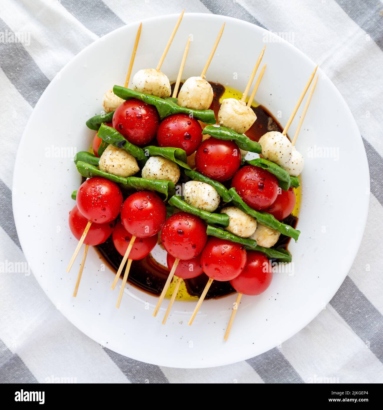 Homemade caprese skewer appetizer on a plate, top view. Flat lay, overhead, from above. Stock Photo