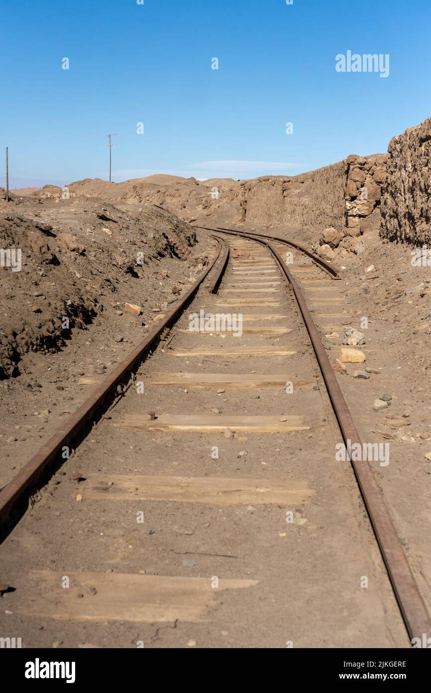 Railroad tracks leading to the Salitrera Santa Laura saltpeter plant.  Humberstone, Chile. Stock Photo