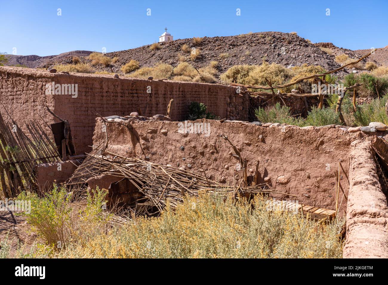 Ruins of an old hacienda with the San Isidro Church in the Catarpe Valley near San Pedro de Atacama in northern Chile. Stock Photo