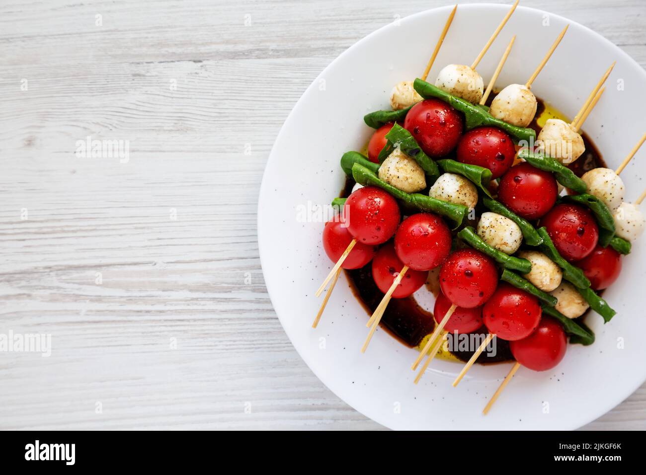 Homemade caprese skewer appetizer on a plate, top view. Flat lay, overhead, from above. Space for text. Stock Photo
