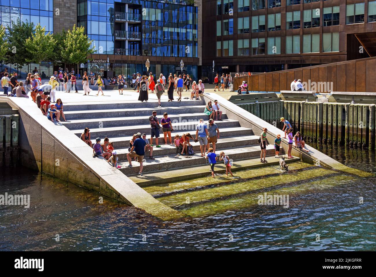 Halifax, Nova Scotia - July 31, 2022: People on the stairs that lead into Halifax Harbour. The stairs located at Queen's Landing were opened in Stock Photo