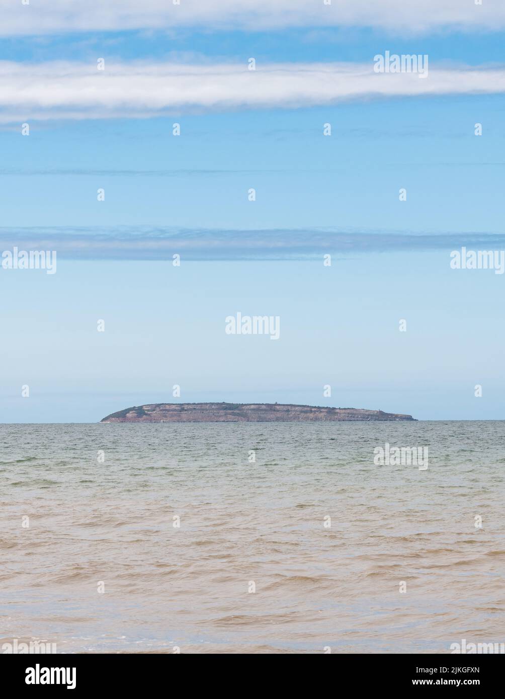 Puffin Island just off the coast of Anglesey, viewed from Penmaenmawr beach, Wales Stock Photo