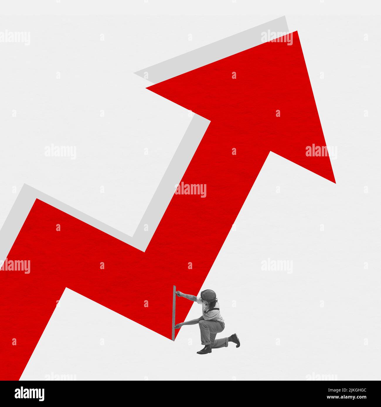 Young man measures huge red arrow as indicator of increase in prices for goods, products and services. Concept of business, analytics, finance Stock Photo