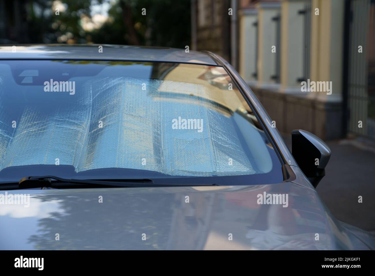 Protective reflective surface under windshield of car on hot day
