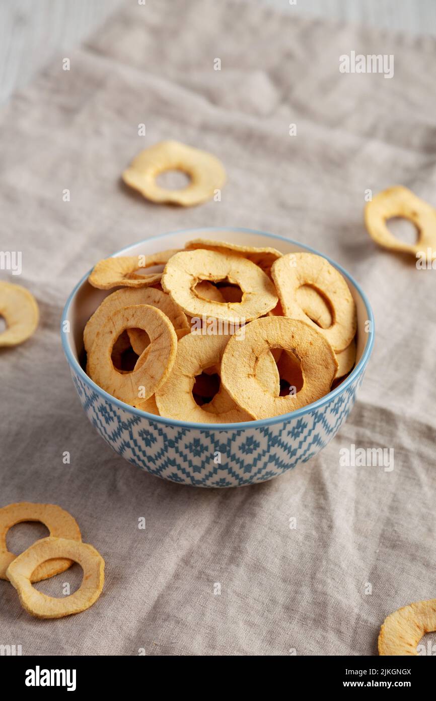 Homemade apple chips in a bowl, side view. Stock Photo