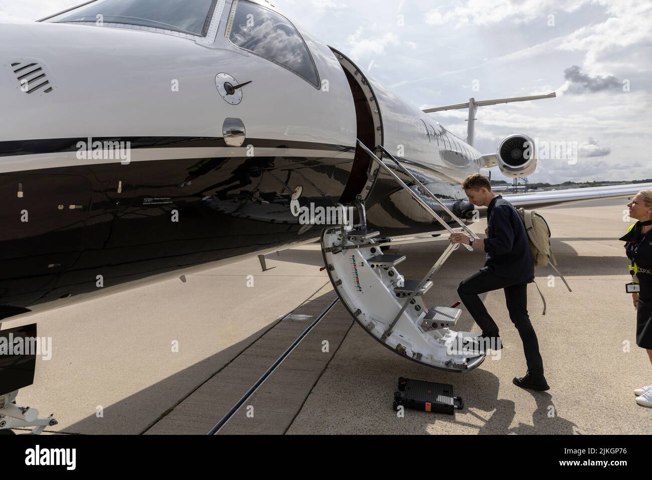 Passenger travelling on a private jet from a UK airport to avoid the airport delays and cancellations many travellers have suffered this year, England. Stock Photo