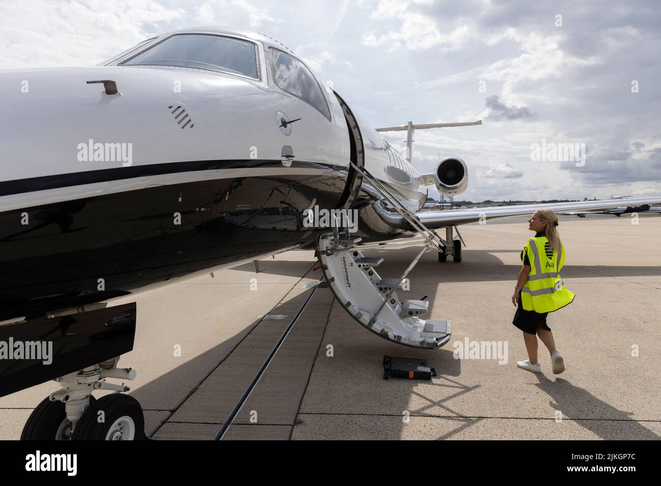 Passenger travelling on a private jet from a UK airport to avoid the airport delays and cancellations many travellers have suffered this year, England. Stock Photo