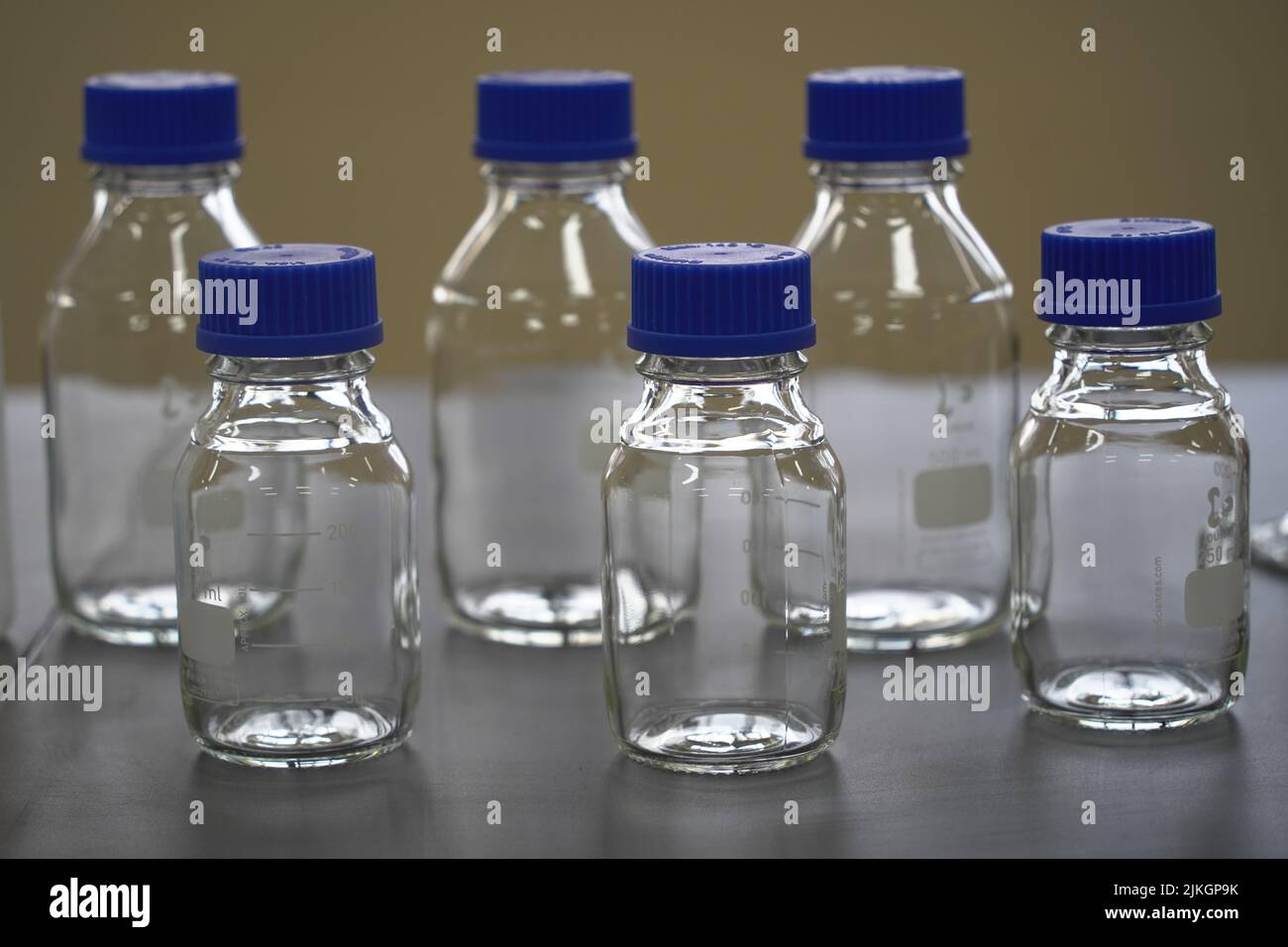 A closeup of reagent transparent bottles in a chemical laboratory Stock Photo Alamy
