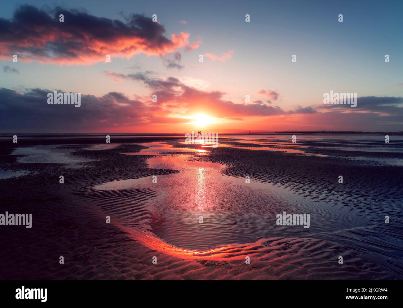 Dramatic sunset over Camber Sands beach in East Sussex, UK Stock Photo